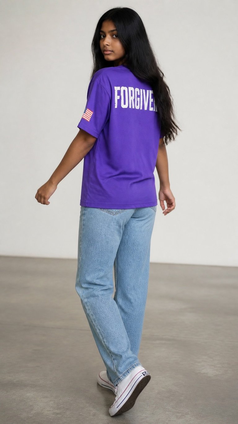 Woman wearing purple graphic t-shirt with FORGIVEN text