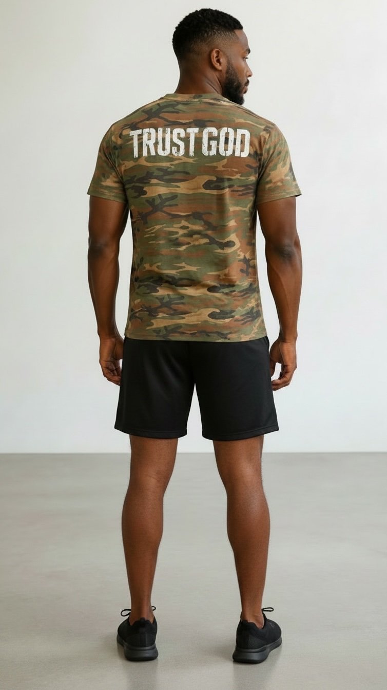 Man wearing camouflage TRUST GOD t-shirt and black shorts