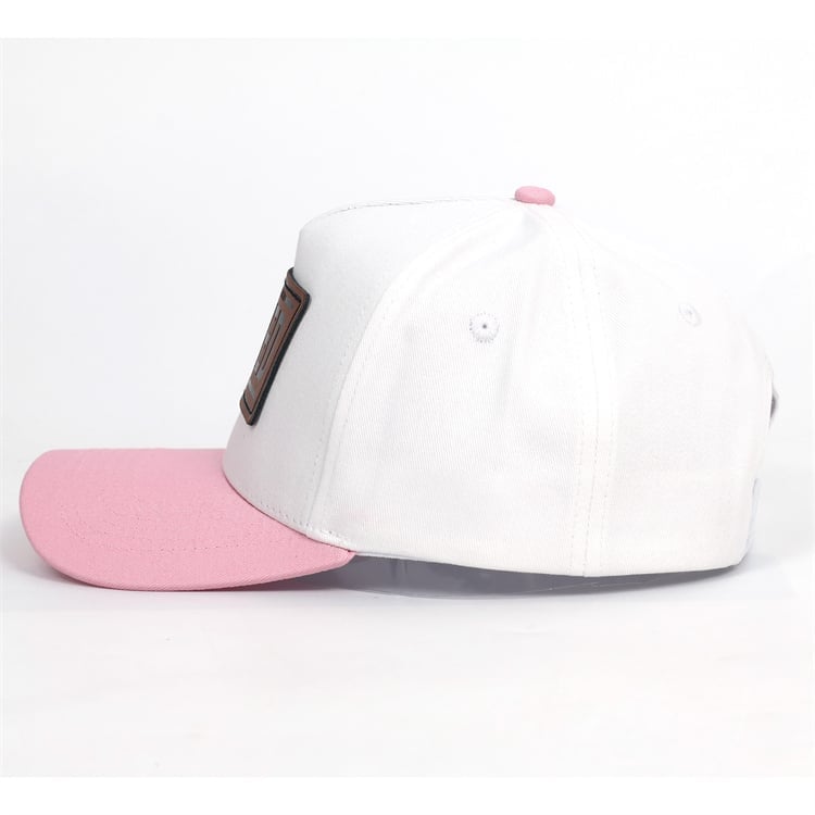 White and pink baseball cap with curved bill shown on white background